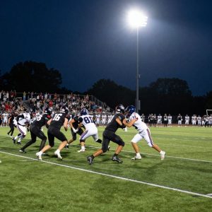 High school athletes playing football on a field during a game in South Carolina.