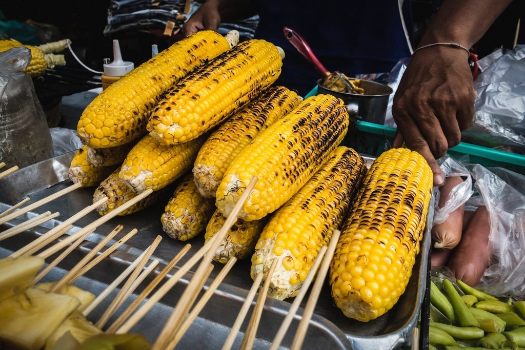 Grilled corn at a festival food stand