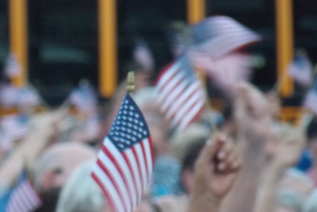 Supporters waving small American flags at a rally