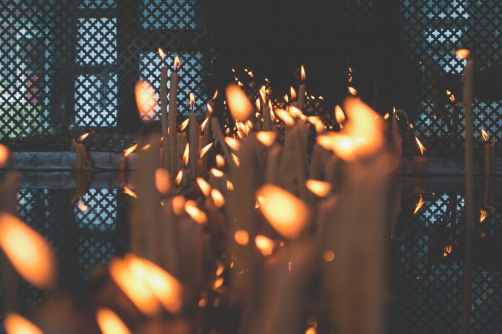 Lit candles glowing in the dark