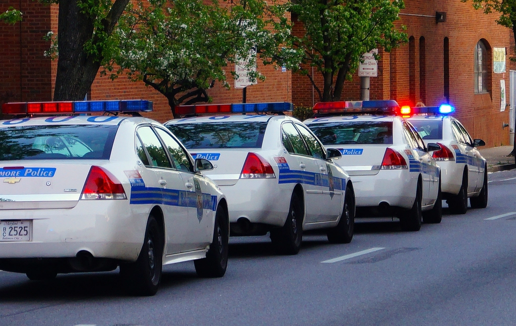 Row of police patrol cars parked along a street